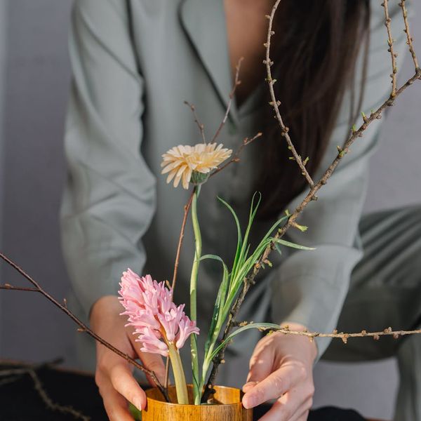 A serene woman meditating, surrounded by soft, natural light, feeling centered.